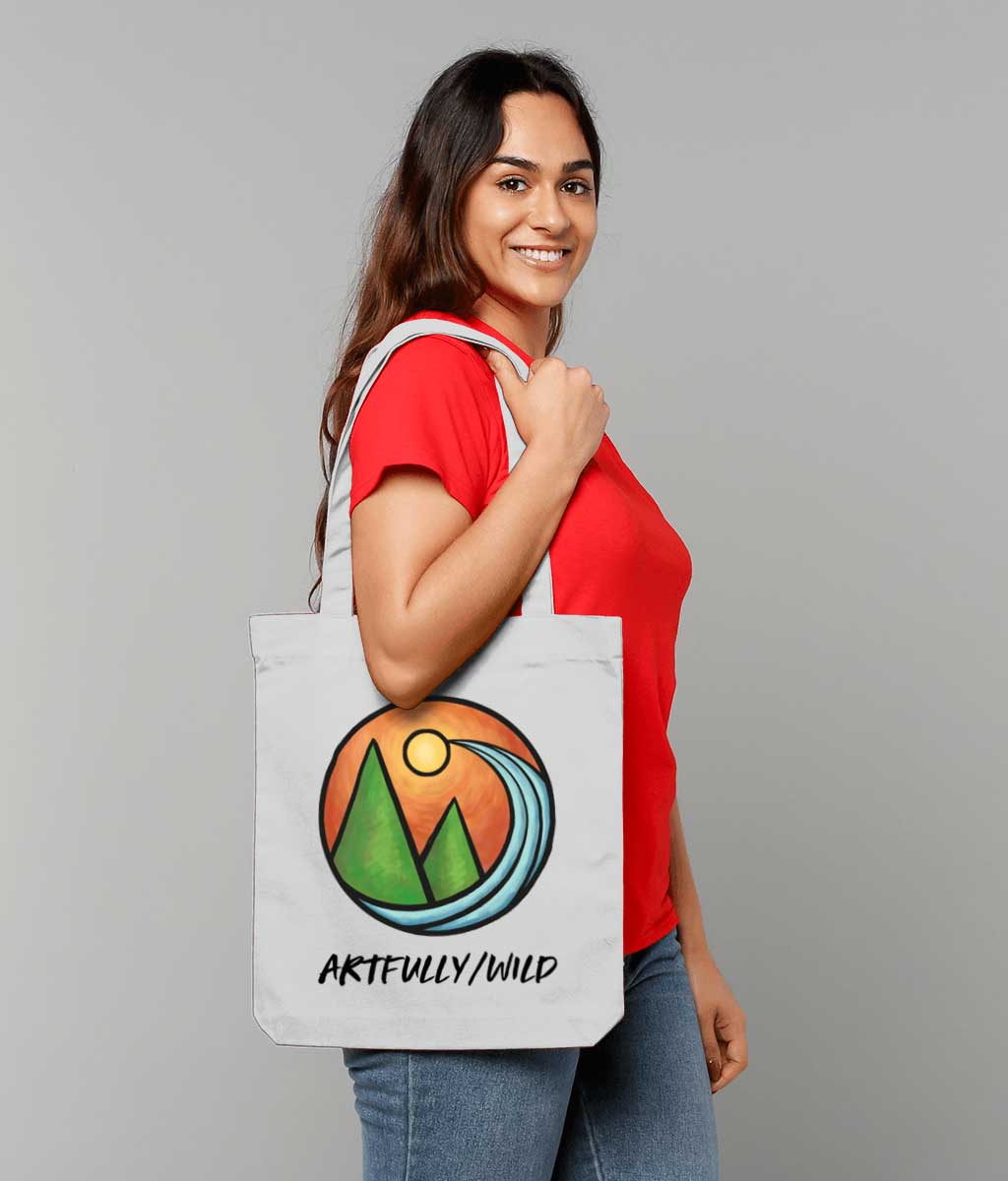 Woman modelling ARTFULLY WILD Grey Recycled Canvas Total Bag. Painted Coloured Landscape Icon. Original Illustration by Artfully/Wild UK.