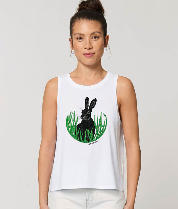 Model wearing ‘HARE IN THE GRASS’ Women’s White Dancer Tank Top Vest Made with Sustainable Organic Cotton. British Wildlife Original Illustration by Artfully/Wild.