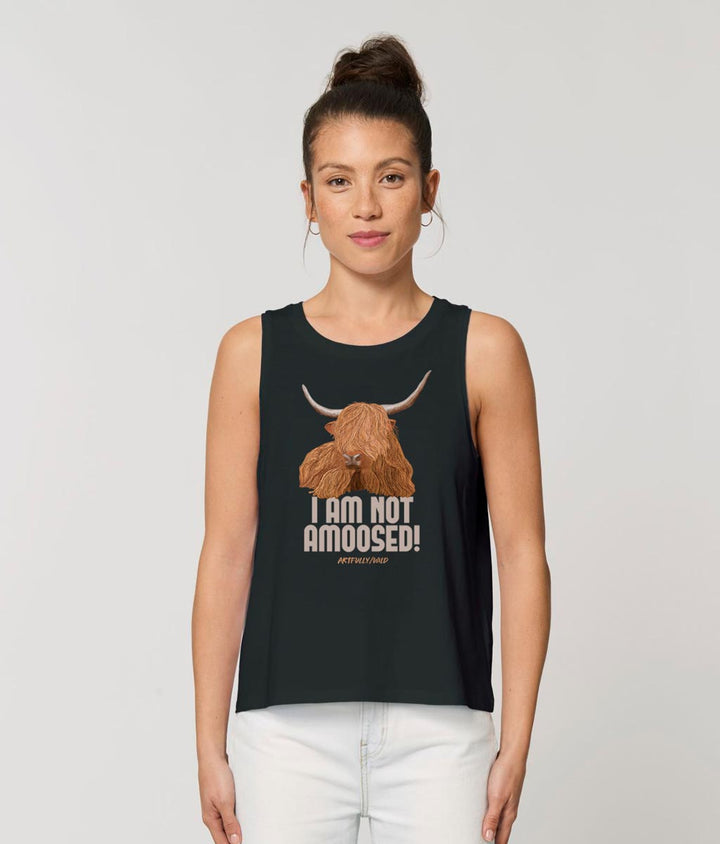Female model wearing ‘I AM NOT AMOOSED’ Women’s Black Dancer Tank Top Vest Made with Sustainable Organic Cotton. Highland Cow Original Illustration by Artfully/Wild.