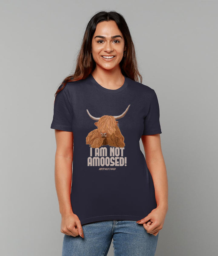 Female model wearing 'I AM NOT AMOOSED' Print on Navy Eco-friendly T-Shirt. Unisex/Women/Men. Certified Organic Clothing. Original Highland Cow Illustration by Artfully/Wild. Printed in the UK.