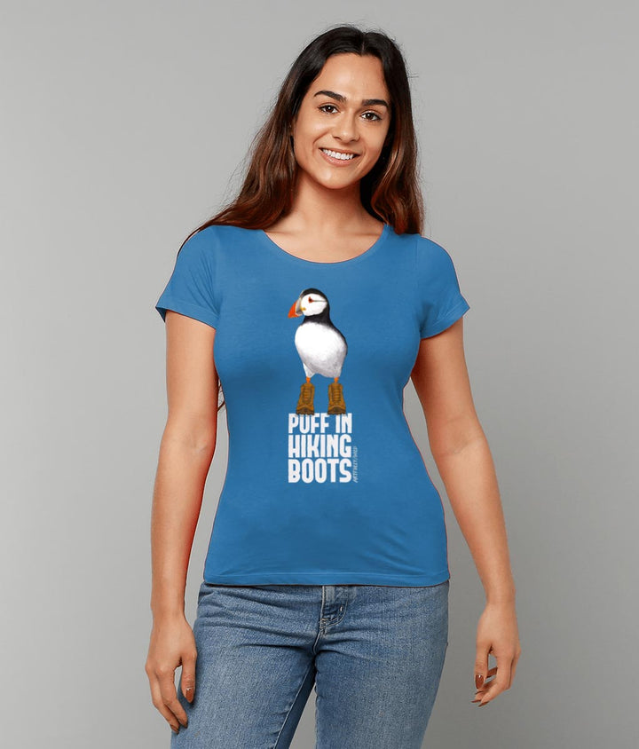 Model wearing ‘PUFF IN HIKING BOOTS’ Women’s Organic Fitted Royal Blue T-Shirt. Sustainable Clothing for wildlife lovers. Original Painted Illustration by Artfully/Wild.