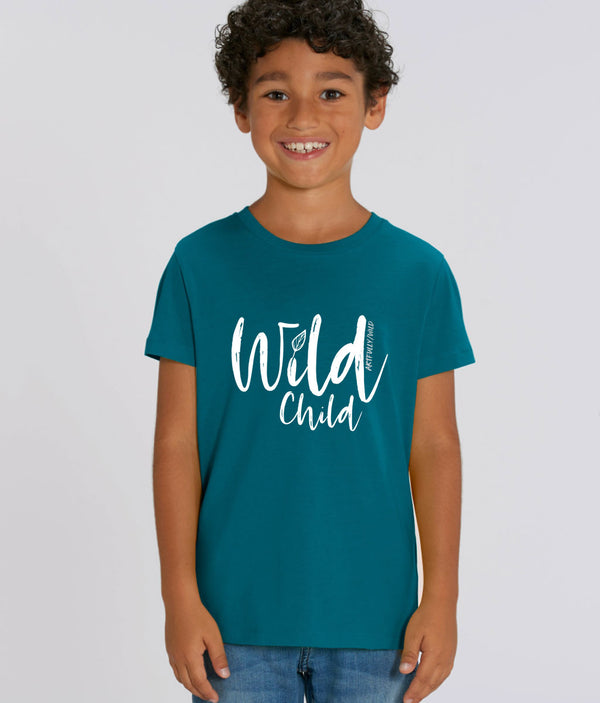 Boy wearing ‘WILD CHILD’ Kids Unisex Ocean Blue T-Shirt. Eco-friendly organic cotton. White slogan print with water-based inks. Original Design by Artfully Wild.